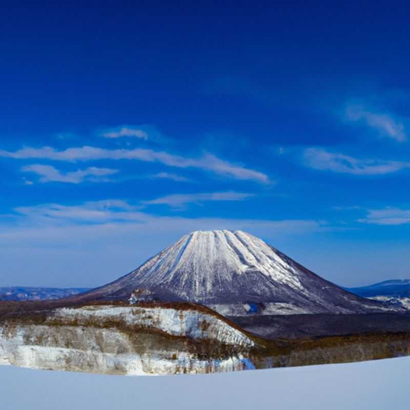 A solo skier glides effortlessly down the pristine slopes of Niseko United, Japan, surrounded by breathtaking mountain scenery, during an unforgettable 24-hour ski adventure in the heart of Hokkaido.